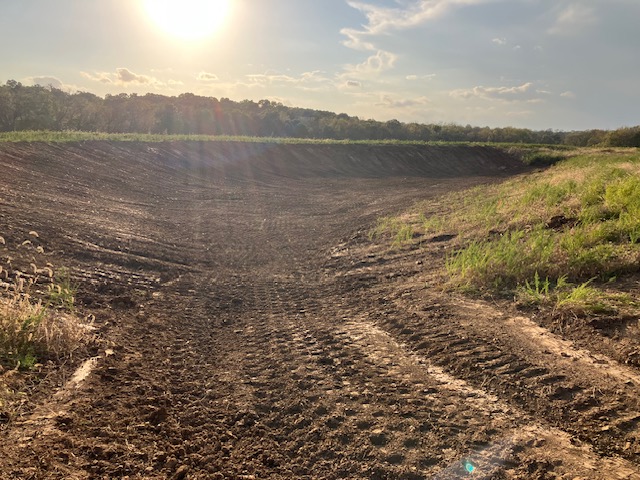 A newly built half-acre pond on the Kincaid family land at sunset